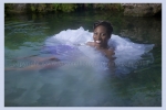 A bride jumps into the water in her wedding dress