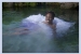 A bride jumps into the water in her wedding dress